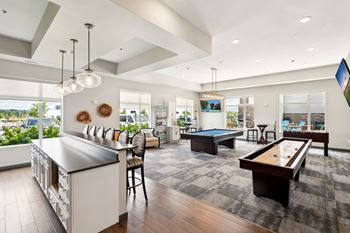 an entertainment clubroom with a demonstration kitchen, a billiards table, and shuffleboard at SoRoc on Maine in Rochester, MN